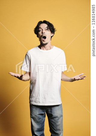 A man posing with a colored bag A man posing with a colored bag 116814985