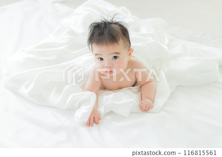 Baby sleeping wrapped in white cloth Baby sleeping wrapped in white cloth 116815561