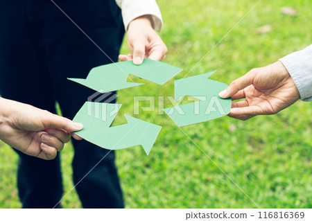 People holding recycle symbol against green spring background. Earth day holiday concept. People holding recycle symbol against green spring background. Earth day holiday concept. 116816369