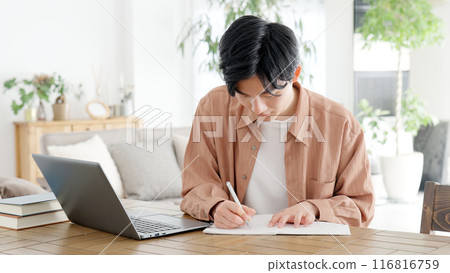 A man studying for a qualification at home A man studying for a qualification at home 116816759