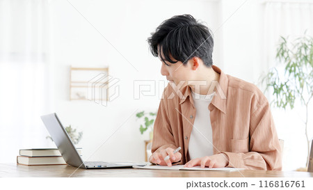 A man studying for a qualification at home 116816761