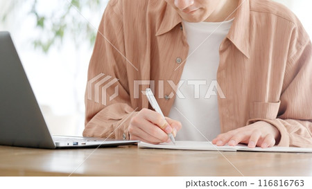 A man studying for a qualification at home 116816763