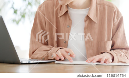 A man studying for a qualification at home 116816764