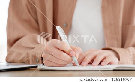 A man studying for a qualification at home 116816767