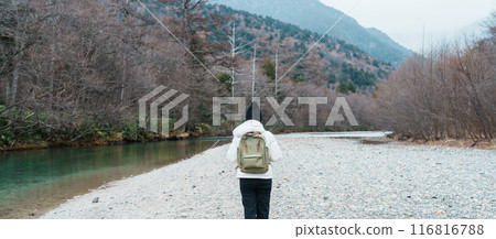 Woman tourist travel Kamikochi National Park, happy Traveler sightseeing Azusa river with mountain, Nagano Prefecture, Japan. Landmark for tourists attraction. Japan Travel, Destination and Vacation 116816788
