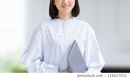 Smiling Japanese business woman with a laptop Smiling Japanese business woman with a laptop 116817031