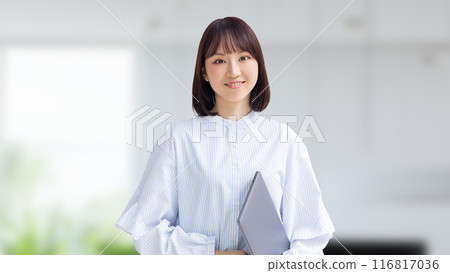 Smiling Japanese business woman with a laptop Smiling Japanese business woman with a laptop 116817036