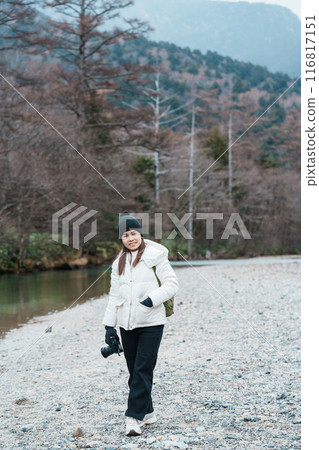 Woman tourist travel Kamikochi National Park, happy Traveler sightseeing Azusa river with mountain, Nagano Prefecture, Japan. Landmark for tourists attraction. Japan Travel, Destination and Vacation 116817151