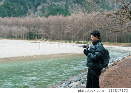 man tourist travel Kamikochi National Park, happy Traveler sightseeing Azusa river with mountain, Nagano Prefecture, Japan. Landmark for tourists attraction. Japan Travel, Destination and Vacation man tourist travel Kamikochi National Park, happy Traveler sightseeing Azusa river with mountain, Nagano Prefecture, Japan. Landmark for tourists attraction. Japan Travel, Destination and Vacation 116817173