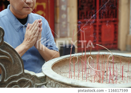 Man Praying Near The Grail With Aroma Sticks Man Praying Near The Grail With Aroma Sticks 116817599