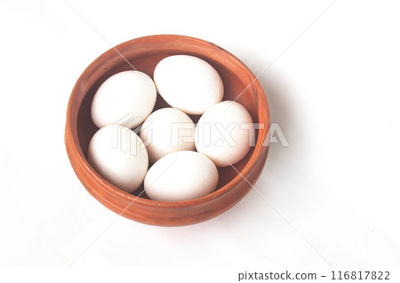 Eggs with white color shell in bowl on isolated white background. White Eggs. Eggs with white color shell in bowl on isolated white background. White Eggs. 116817822