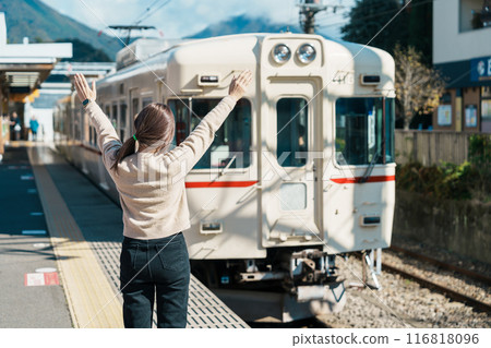 Woman tourist with local train at Otsuki station during trip to Kawaguchiko station, happy Traveler sightseeing Mount Fuji in Yamanashi, Japan. Japan Travel, Destination and Vacation conccept 116818096