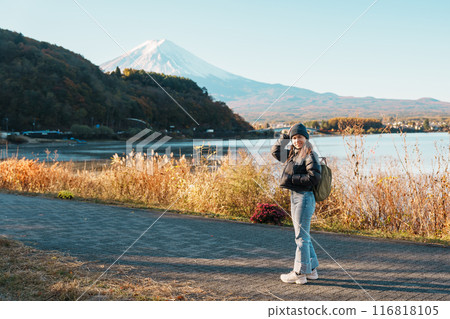 Woman tourist with Fuji Mountain at Lake Kawaguchi, happy Traveler sightseeing Mount Fuji in Fujikawaguchiko, Yamanashi, Japan. Landmark for tourists attraction. Japan Travel, Destination and Vacation Woman tourist with Fuji Mountain at Lake Kawaguchi, happy Traveler sightseeing Mount Fuji in Fujikawaguchiko, Yamanashi, Japan. Landmark for tourists attraction. Japan Travel, Destination and Vacation 116818105