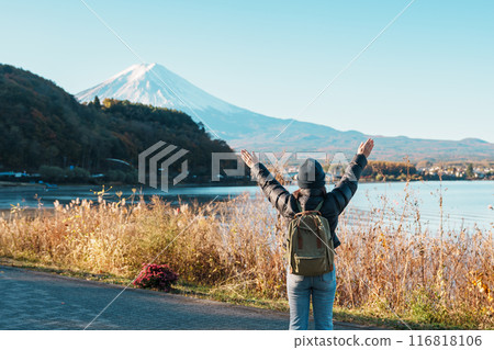 Woman tourist with Fuji Mountain at Lake Kawaguchi, happy Traveler sightseeing Mount Fuji in Fujikawaguchiko, Yamanashi, Japan. Landmark for tourists attraction. Japan Travel, Destination and Vacation Woman tourist with Fuji Mountain at Lake Kawaguchi, happy Traveler sightseeing Mount Fuji in Fujikawaguchiko, Yamanashi, Japan. Landmark for tourists attraction. Japan Travel, Destination and Vacation 116818106