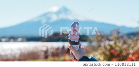 Woman hand holding ice cream in a cone with Mt Fuji at Lake Kawaguchi, happy Traveler sightseeing Mount Fuji in Oishi park. Landmark for tourists attraction. Japan Travel, Destination and Vacation Woman hand holding ice cream in a cone with Mt Fuji at Lake Kawaguchi, happy Traveler sightseeing Mount Fuji in Oishi park. Landmark for tourists attraction. Japan Travel, Destination and Vacation 116818111
