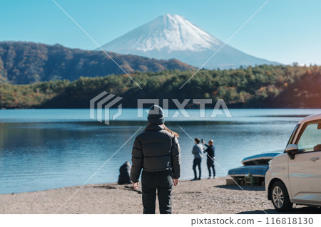 Woman tourist enjoy with Fuji Mountain at Lake Saiko, happy Traveler sightseeing Mount Fuji and road trip Fuji Five Lakes. Landmark for tourists attraction. Japan Travel, Destination and Vacation 116818130