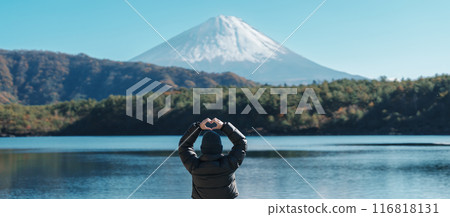 Woman tourist enjoy with Fuji Mountain at Lake Saiko, happy Traveler sightseeing Mount Fuji and road trip Fuji Five Lakes. Landmark for tourists attraction. Japan Travel, Destination and Vacation 116818131