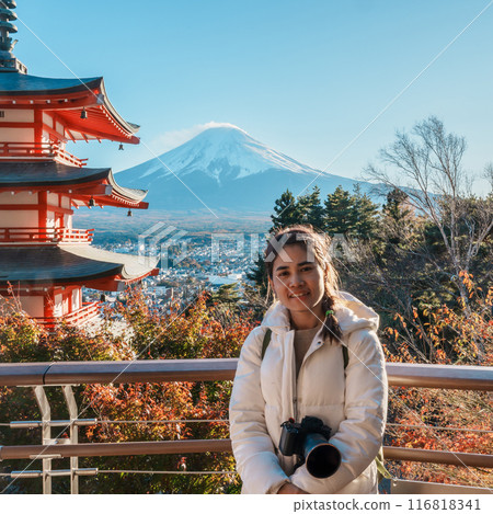 Woman tourist with mount Fuji at Chureito Pagoda in Autumn season, Traveler travel Arakurayama Sengen Park, Yamanashi, Japan. Landmark for tourist attraction. Japan Travel, Destination and Vacation 116818341