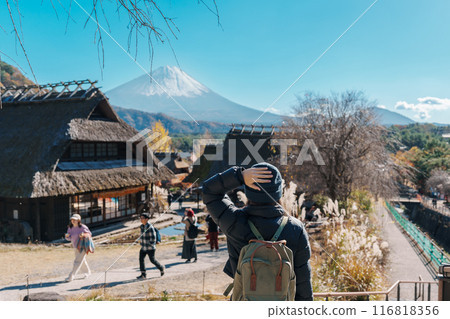 Woman tourist with mount Fuji at Saiko Iyashino Sato Nenba in Autumn season, happy Traveler travel Mt Fuji, Yamanashi, Japan. Landmark for tourist attraction. Japan Travel, Destination and Vacation 116818356