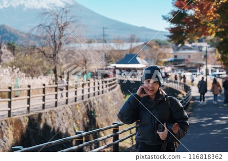 Woman tourist with mount Fuji at Saiko Iyashino Sato Nenba in Autumn season, happy Traveler travel Mt Fuji, Yamanashi, Japan. Landmark for tourist attraction. Japan Travel, Destination and Vacation Woman tourist with mount Fuji at Saiko Iyashino Sato Nenba in Autumn season, happy Traveler travel Mt Fuji, Yamanashi, Japan. Landmark for tourist attraction. Japan Travel, Destination and Vacation 116818362