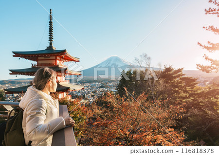Woman tourist with mount Fuji at Chureito Pagoda in Autumn season, Traveler travel Arakurayama Sengen Park, Yamanashi, Japan. Landmark for tourist attraction. Japan Travel, Destination and Vacation 116818378