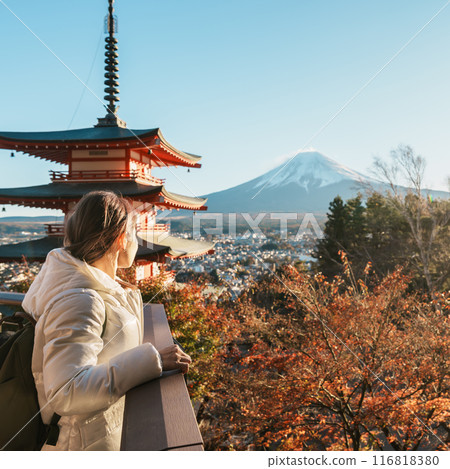 Woman tourist with mount Fuji at Chureito Pagoda in Autumn season, Traveler travel Arakurayama Sengen Park, Yamanashi, Japan. Landmark for tourist attraction. Japan Travel, Destination and Vacation 116818380