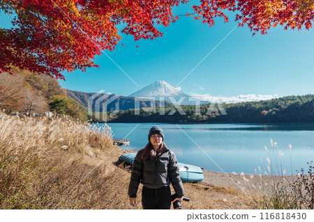 Woman tourist with Fuji Mountain at Lake Saiko in Autumn season, happy Traveler travel Mount Fuji, Yamanashi, Japan. Landmark for tourists attraction. Japan Travel, Destination and Vacation Woman tourist with Fuji Mountain at Lake Saiko in Autumn season, happy Traveler travel Mount Fuji, Yamanashi, Japan. Landmark for tourists attraction. Japan Travel, Destination and Vacation 116818430