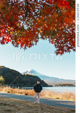 man tourist with Fuji Mountain at Lake Kawaguchi in Autumn season, happy Traveler travel Mount Fuji, Yamanashi, Japan. Landmark for tourists attraction. Japan Travel, Destination and Vacation man tourist with Fuji Mountain at Lake Kawaguchi in Autumn season, happy Traveler travel Mount Fuji, Yamanashi, Japan. Landmark for tourists attraction. Japan Travel, Destination and Vacation 116818556