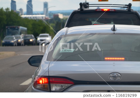 Calgary, Alberta, Canada. Jul 01, 2024. An Uber sign on a vehicle car on the road. Calgary, Alberta, Canada. Jul 01, 2024. An Uber sign on a vehicle car on the road. 116819299