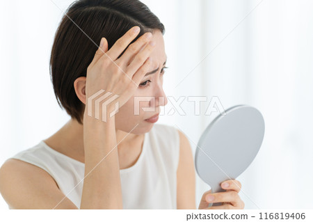 Beauty image of a young woman doing hair care 116819406