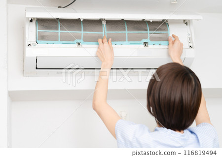 Young woman cleaning air conditioner filters Lifestyle image 116819494