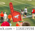 Calgary, Alberta, Canada. Jul 21, 2024. A fan holding a red foam finger with a Calgary Stampeders logo, cheering. 116819598