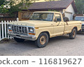Calgary, Alberta, Canada. Jul 21, 2024. A sunny suburban scene with a yellow pickup truck A Ford F-Series Ranger model parked in the driveway of a neat two-story house. 116819627