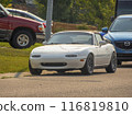 Calgary, Alberta, Canada. Jul 17, 2024. A white Mazda MX-5 Miata parked on a suburban street, its compact and sporty design, features a soft-top roof and custom alloy wheels. 116819810
