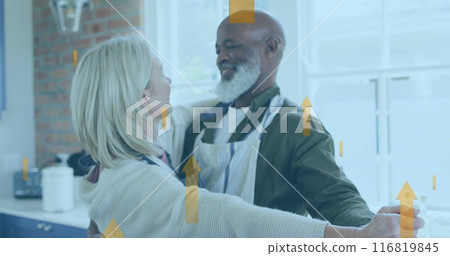 Image of multiple up arrow over diverse couple dancing wearing apron at home 116819845