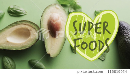 Image of super foods text on green heart over avocado on green background 116819954
