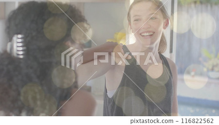 Image of light spots over happy diverse teenage girls practicing yoga together 116822562