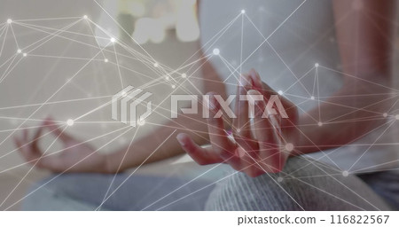 Image of network over midsection of african american woman practicing yoga meditation 116822567
