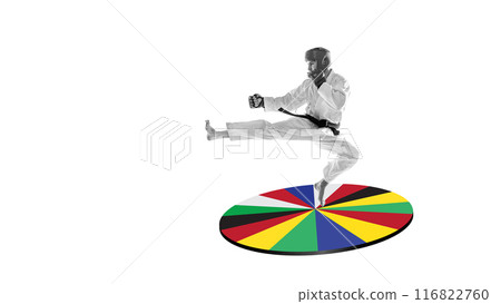 Martial artist in monochrome performing high kick over vivid circle of international flags against white background. Creative design. Art collage. 116822760