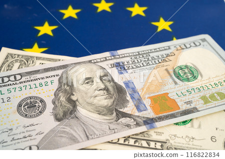US dollar banknotes on EU flag background, Business and finance. US dollar banknotes on EU flag background, Business and finance. 116822834