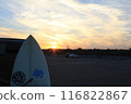 Surfboard illuminated by the setting sun 116822867