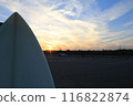 Surfboard illuminated by the setting sun 116822874