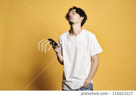 A man touching a smartphone with a colored background 116823227