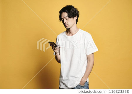 A man touching a smartphone with a colored background A man touching a smartphone with a colored background 116823228