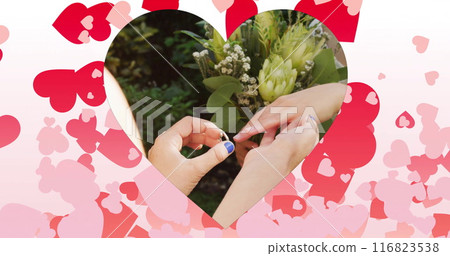 Image of hearts floating over diverse female couple proposing Image of hearts floating over diverse female couple proposing 116823538