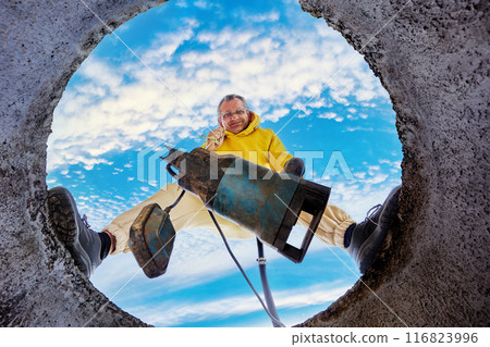 Septic tank pumping, with sewage pump that homeowner immerses in sump pit, bottom view. 116823996