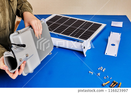 DIY assembly of outdoor lighting, LED light with solar panel will be fixed on mounting bracket. 116823997