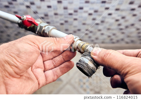 Crimp collet compression fitting angle with transition to an external thread in hands of plumber that eliminates leaks. Crimp collet compression fitting angle with transition to an external thread in hands of plumber that eliminates leaks. 116824015