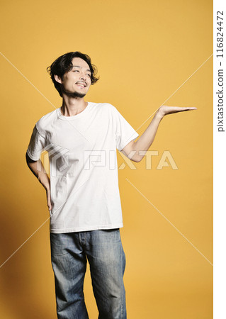 A man posing as a guide on a colored background 116824472