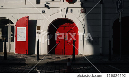 Red double door with harsh shadow 116824592